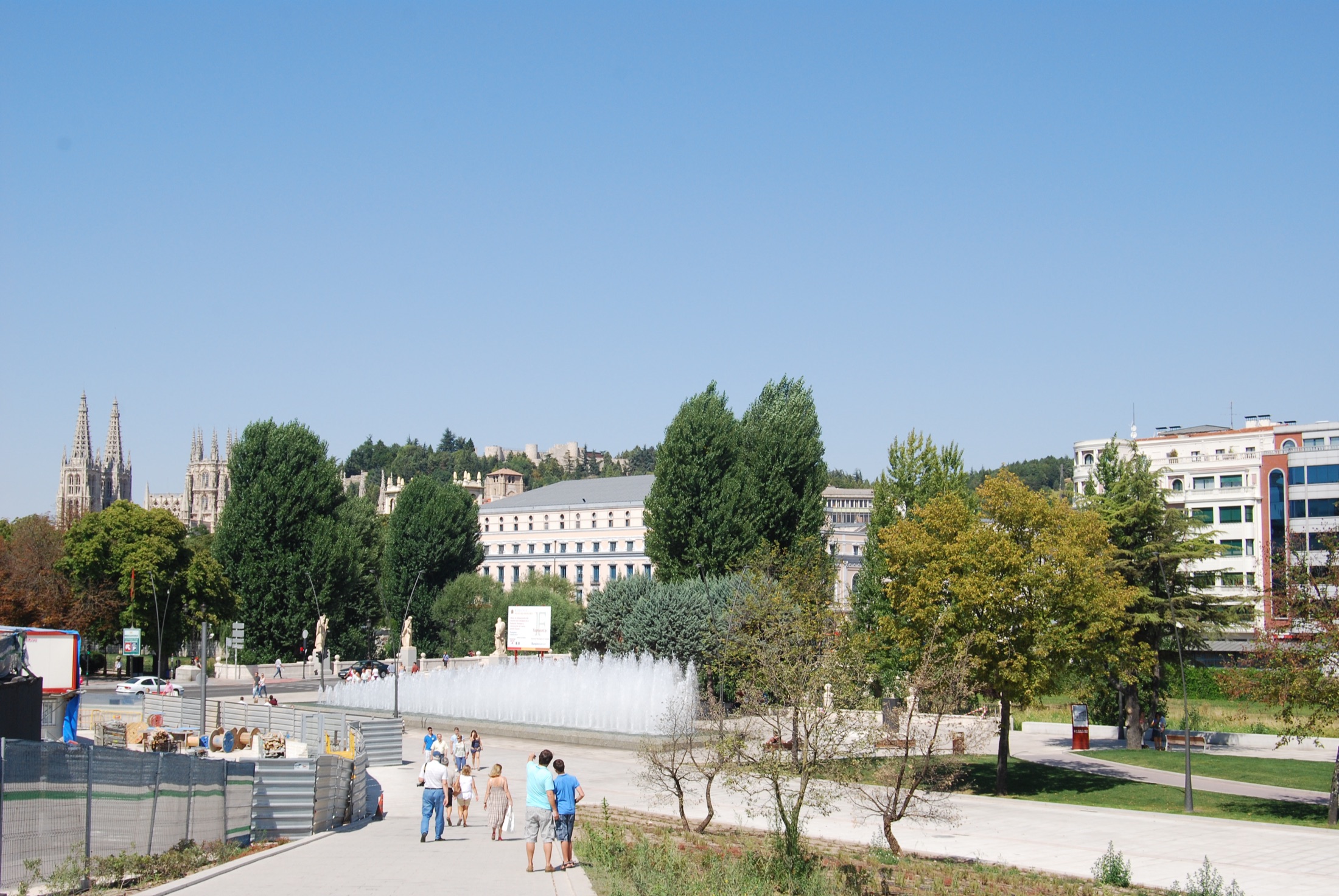 View across Burgos to the cathedral spires with the wooded Cerro del Castillo, castle ruins on its crest, rising directly above the old town