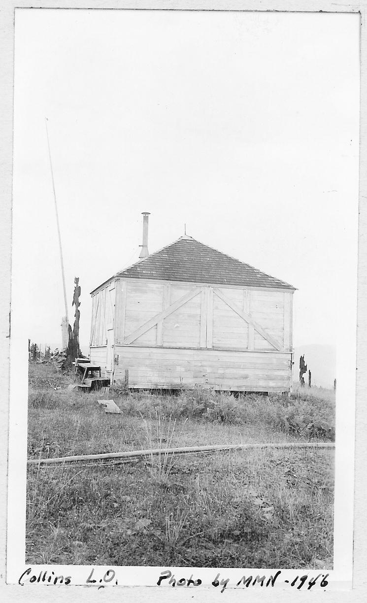 A simple wooden fire lookout cabin on a bare summit, 1946