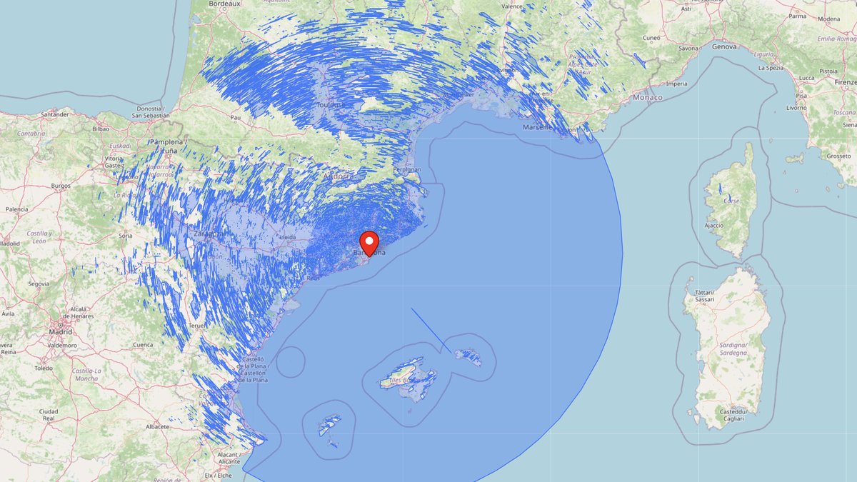 UpToWhere 360° viewshed computed from 11,000 m above Barcelona: a huge visible-area disc over the Mediterranean reaching Corsica, with terrain shadows across Spain and France
